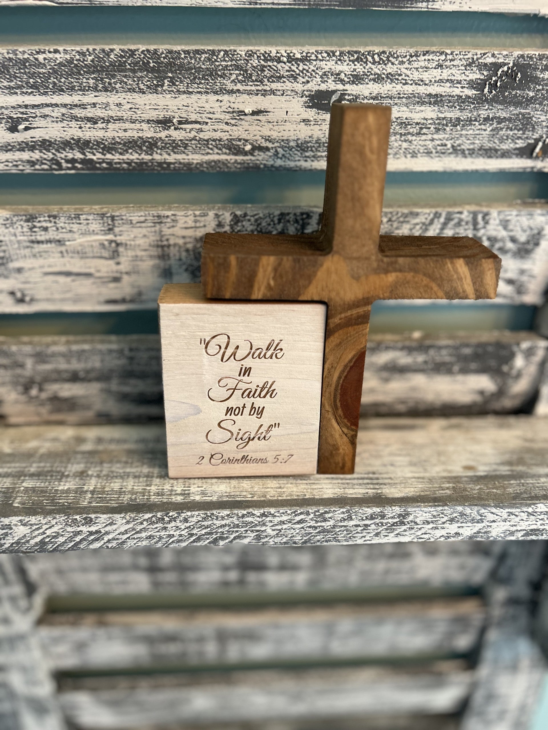 Handcrafted wooden cross and plaque with 2 Corinthians 5:7 on rustic shelf, Port Royal Woodworks