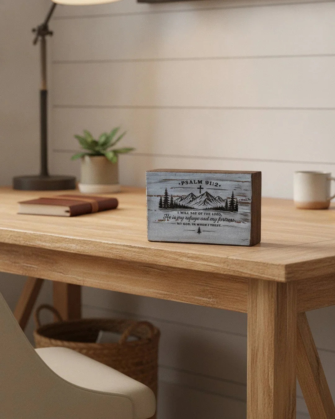 Wooden home decor with Psalm 91:2 scripture and mountain design on rustic desk