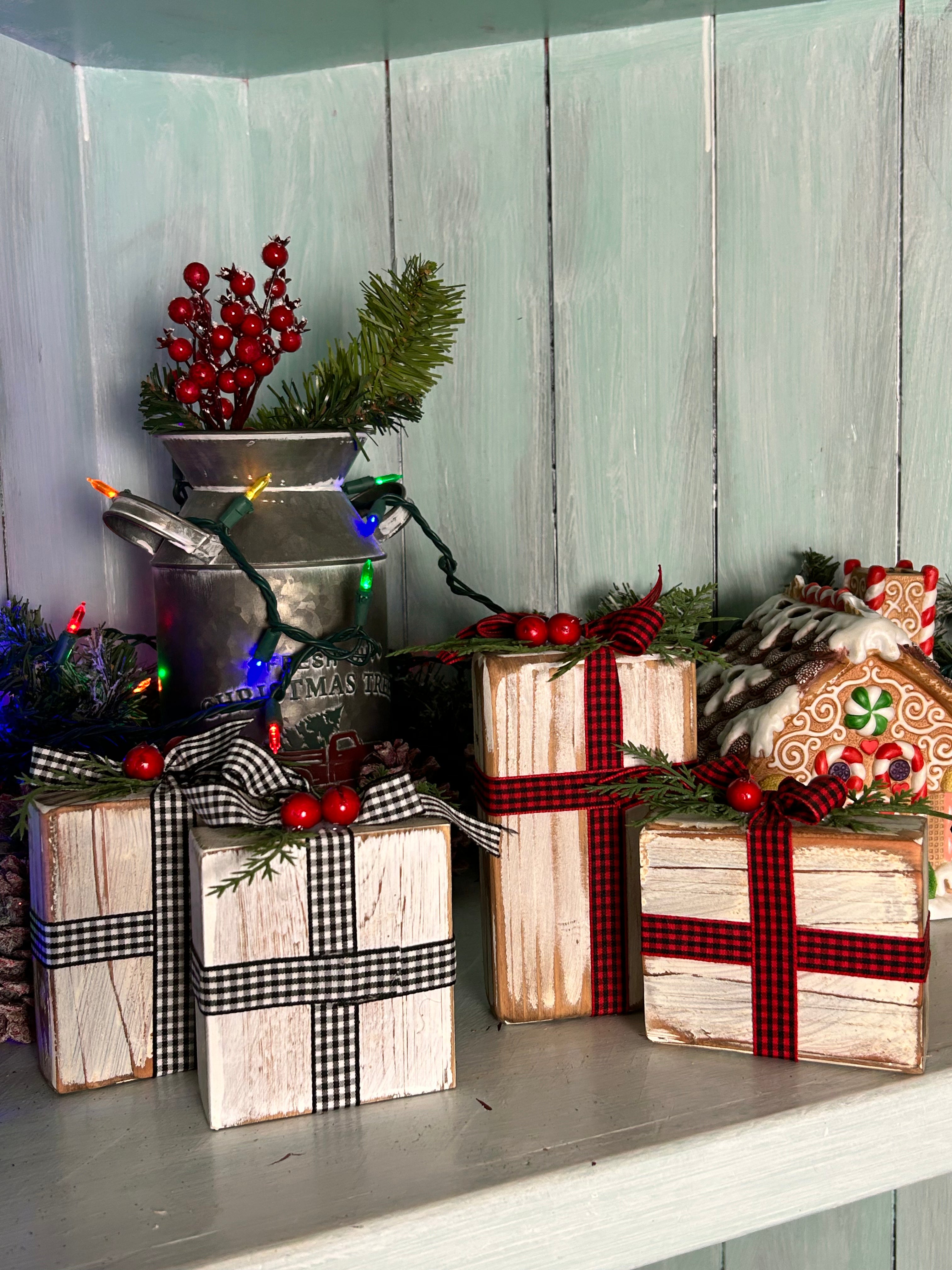 Handcrafted whitewashed wooden Christmas boxes with festive ribbons and bows