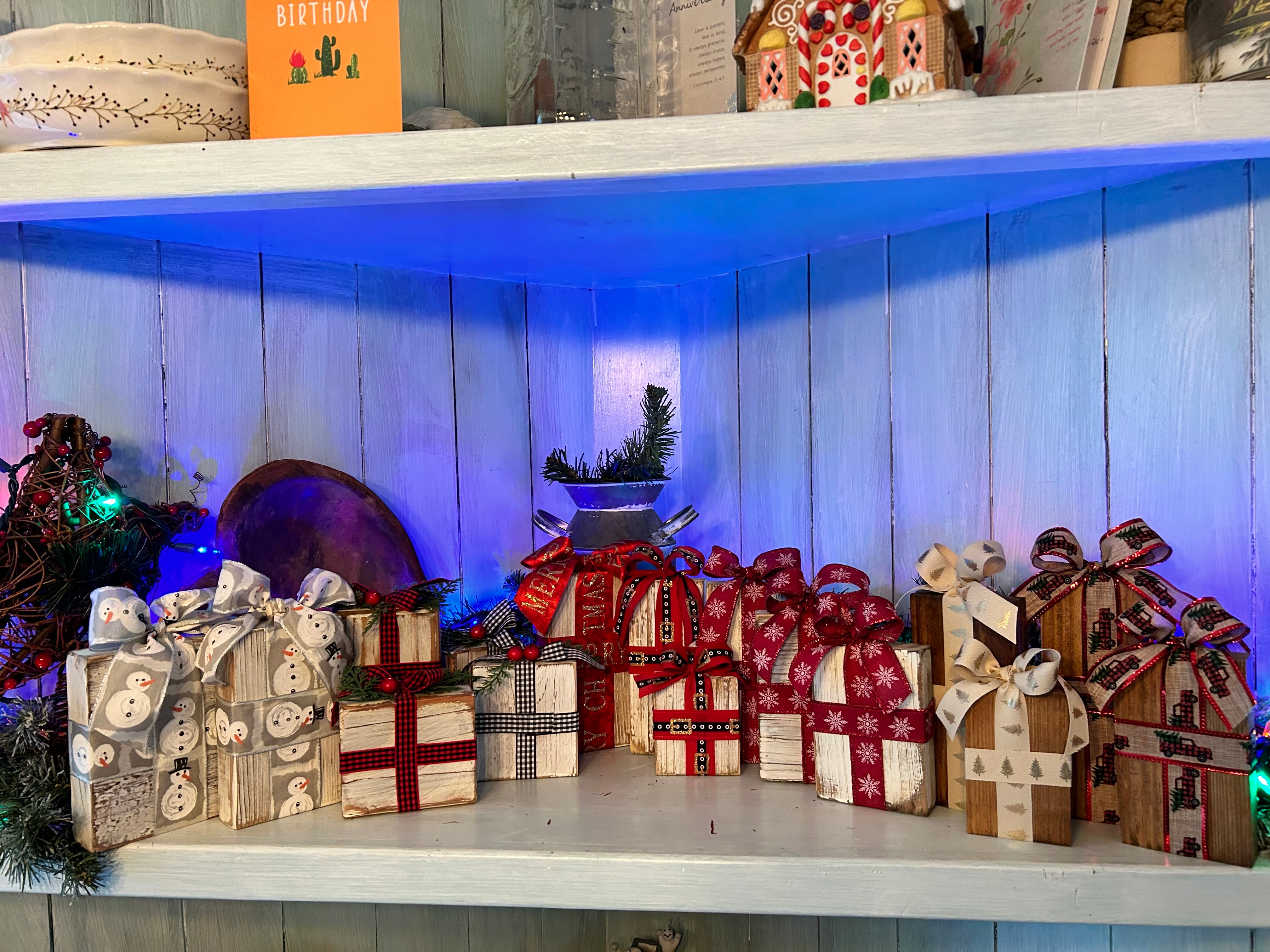 Handcrafted whitewashed and maple-stained wooden Christmas boxes with festive ribbons and bows