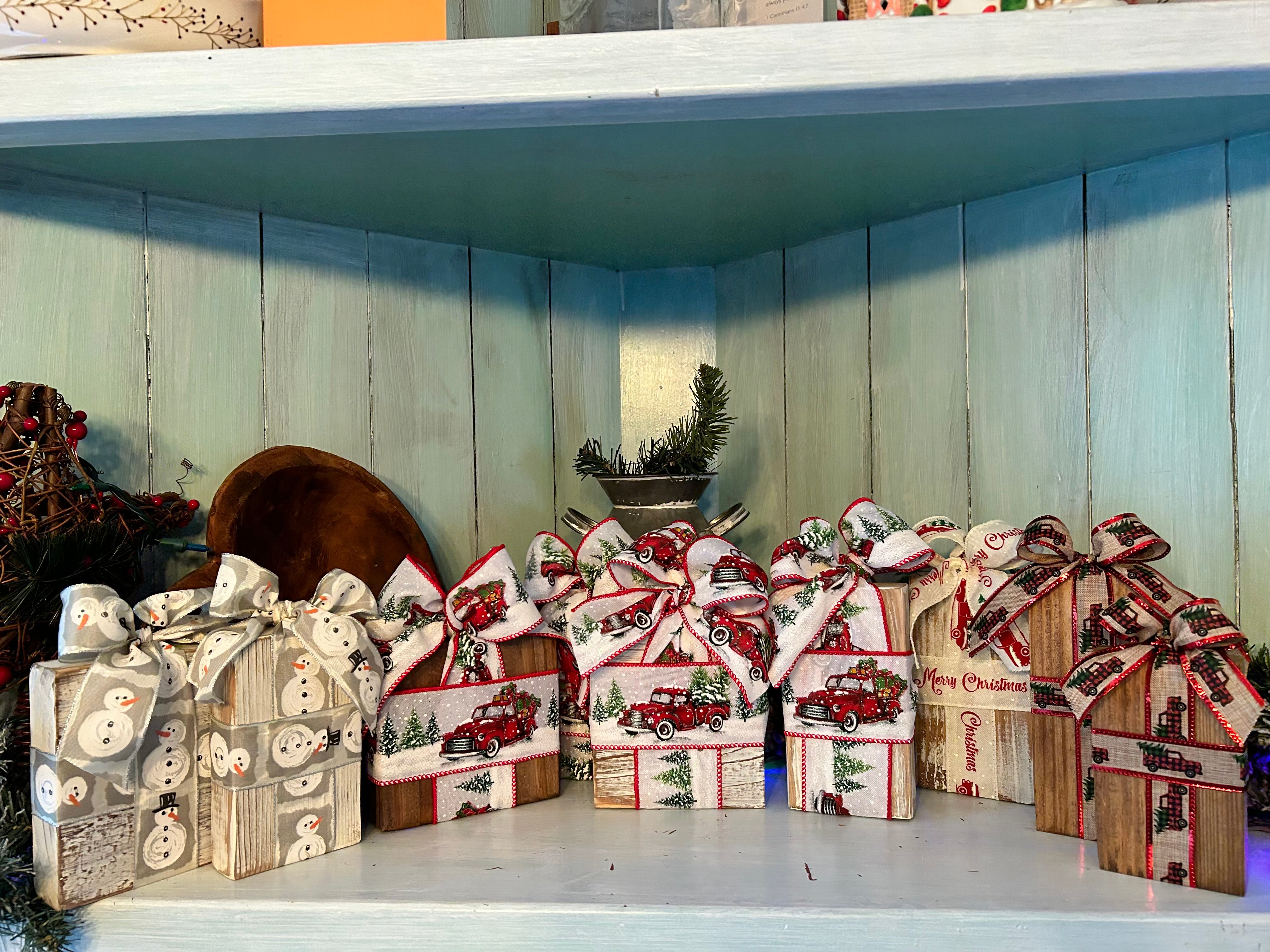 Handcrafted whitewashed and maple-stained wooden Christmas boxes with festive ribbons and bows
