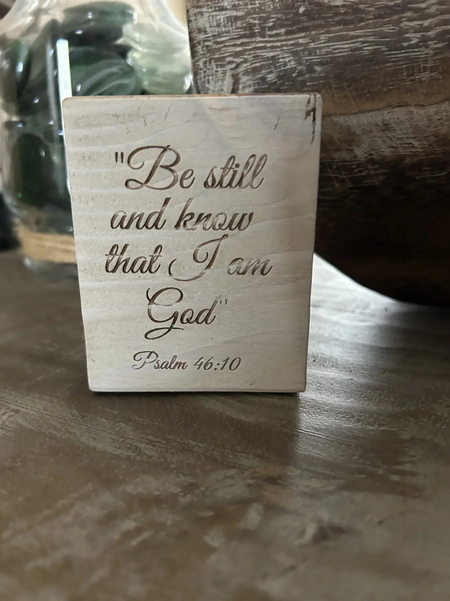 Engraved wooden scripture block by Port Royal Woodworks on rustic table, Psalm 46:10