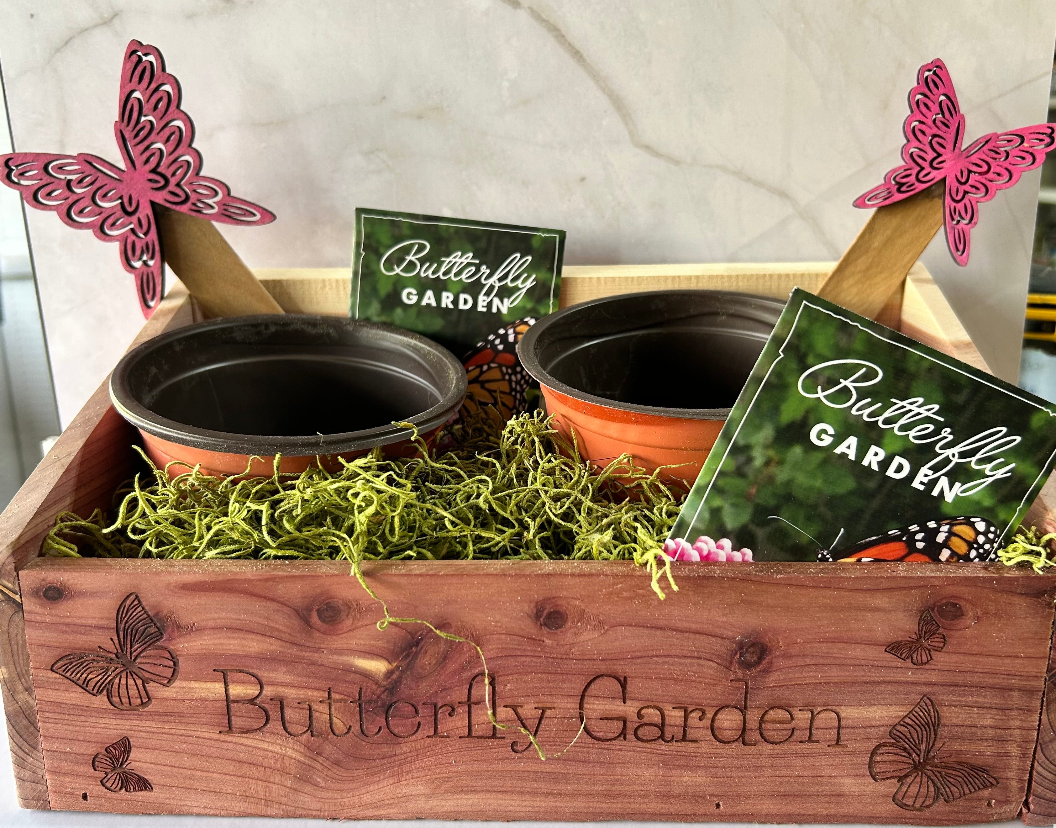 Handcrafted Eastern Red Cedar Butterfly Garden with engraved butterfly designs, displayed on a sunny patio with Monarch Wildflower Seed Mix packet.